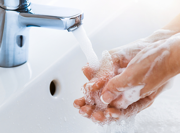 DG - Woman use soap and washing hands under the water tap