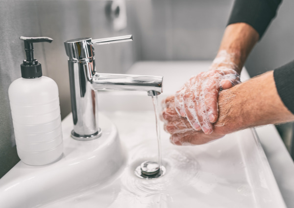 Man rubbing his hands with soap