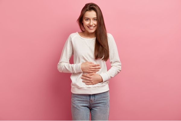 Woman keeps both hands on belly