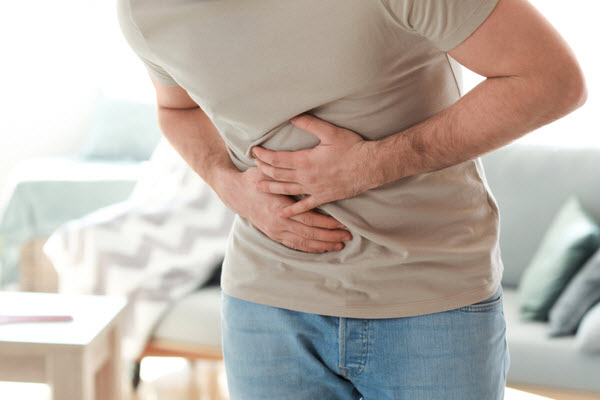 Man suffering from stomachache at home